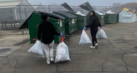 Green Team members Toulen Xiong and Arpanjot Dosanjh hauled bags of waste they found around the school area to the campus trash bins on Dec. 17.