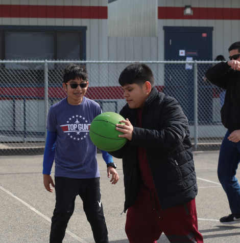 Marco Falcon and Francisco Regalado III playing basketball on the courts during Special Olympics PE on Feb. 23.