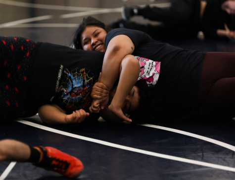 Madison Robinson and Yvette Garcia practincing for the next wrestling match. (BOTTOM) Lailanie Vongnakhone practicing with her partner.