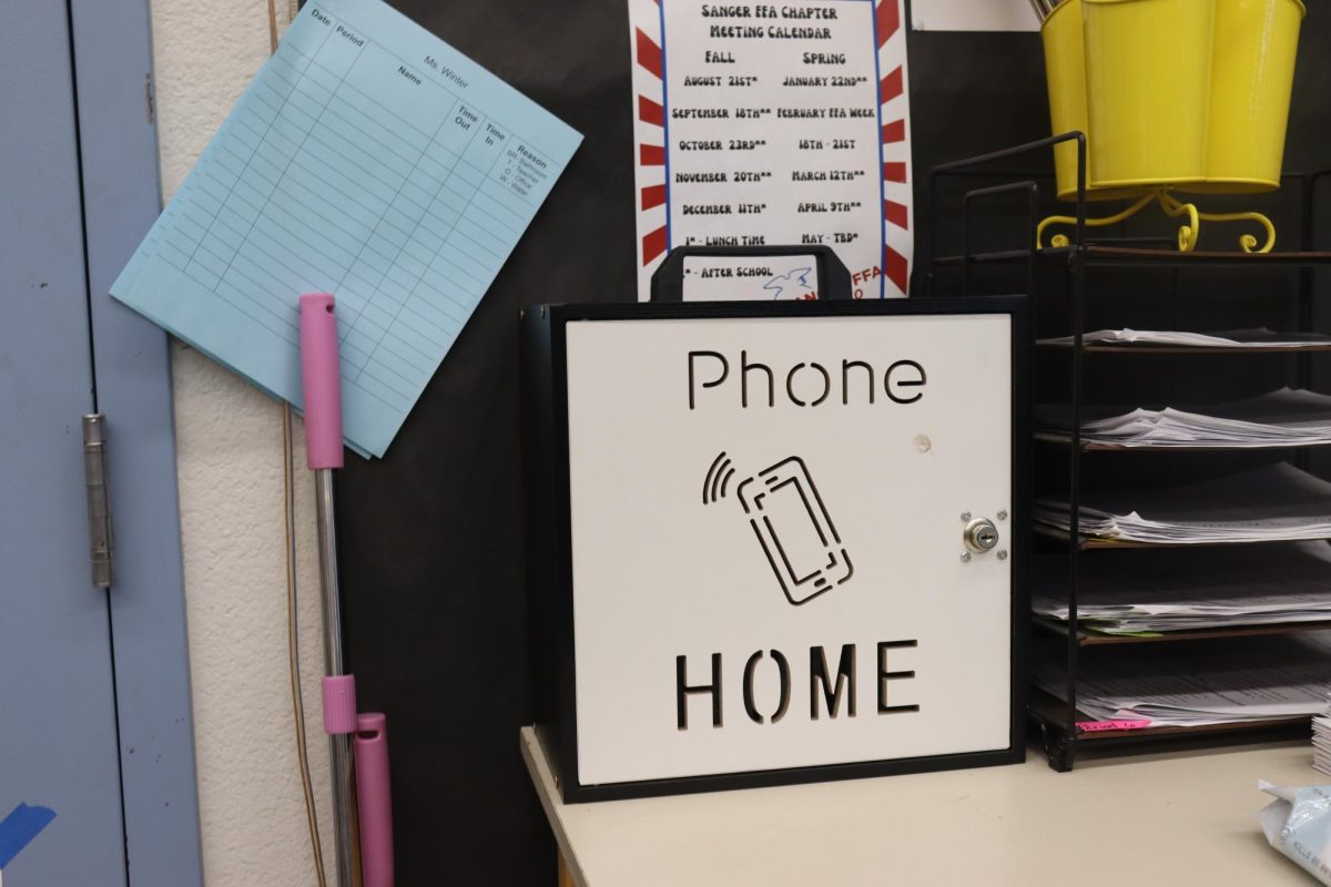 Teacher Julia Winters displays her phone box holding the cellphones of students. 