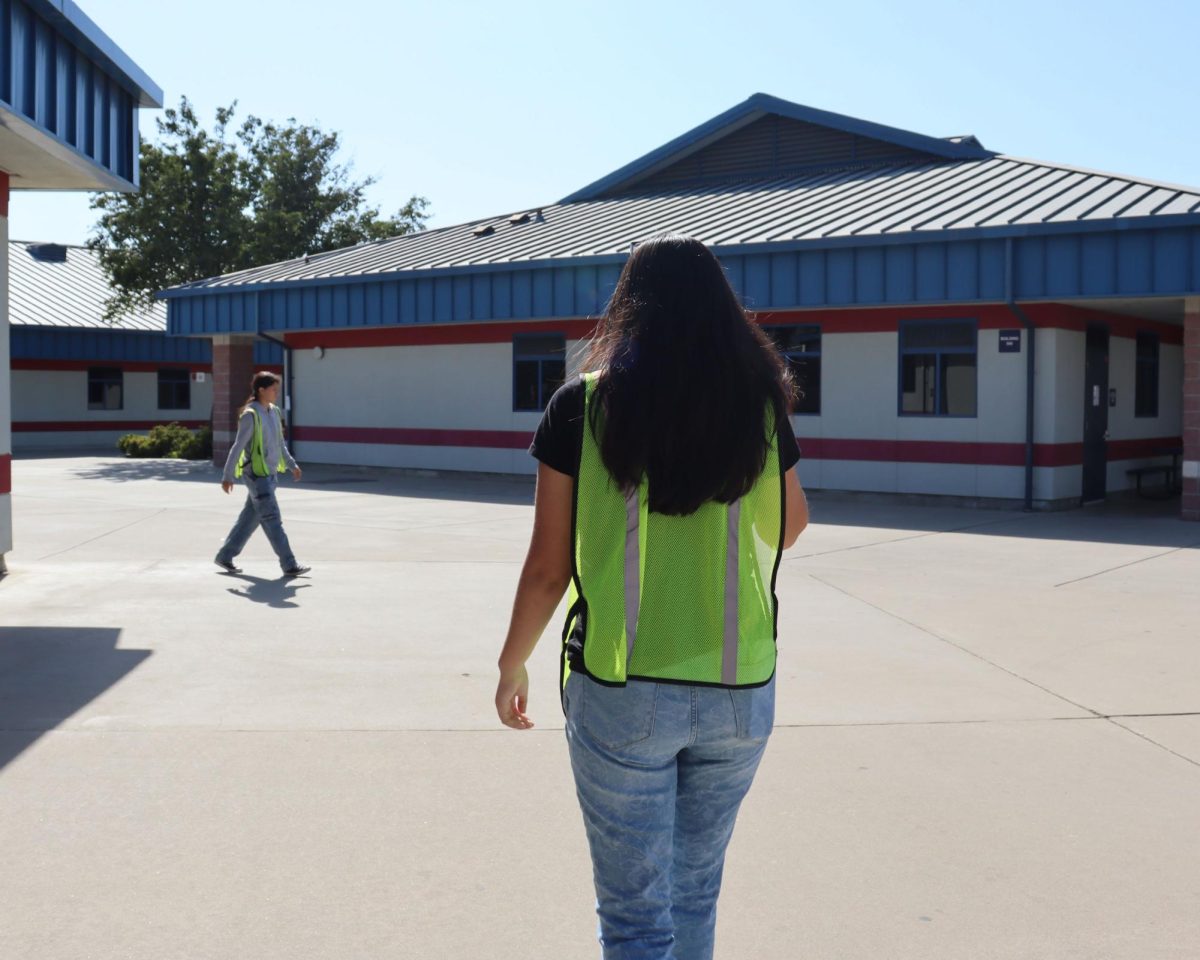 Students walking around the campus using the new bathroom vests. 