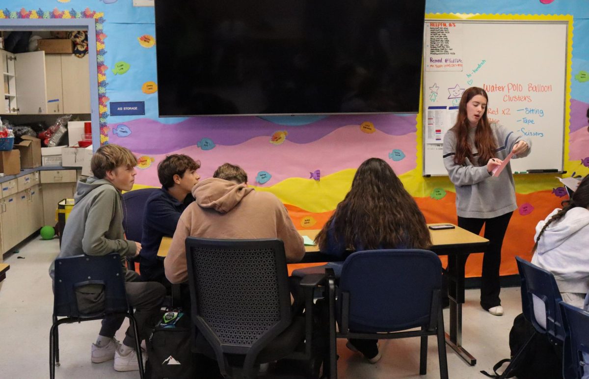 Mackenzie Scott explaining to ASB students how to write a thank you card for staff. 