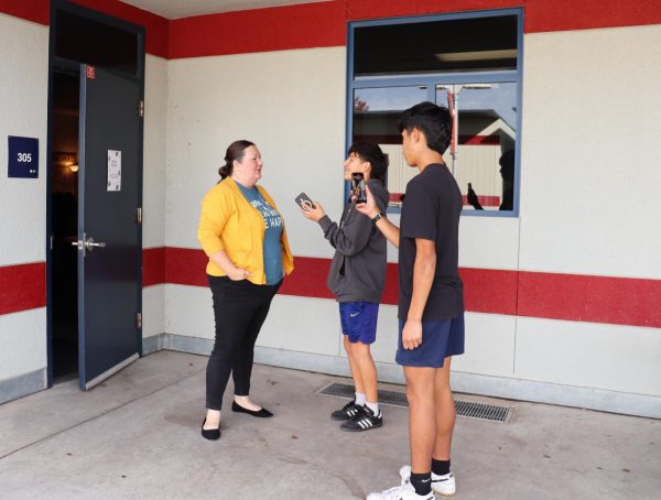 Nash Lucero and Lalo Cuellar recording an interview with English teacher Nicole Roland for Sanger High Quote of the Day. 